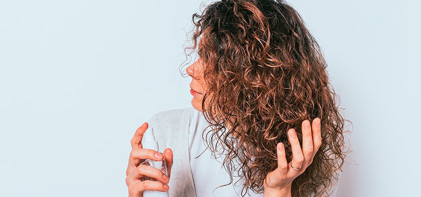 девушка увлажняет сухие волосы